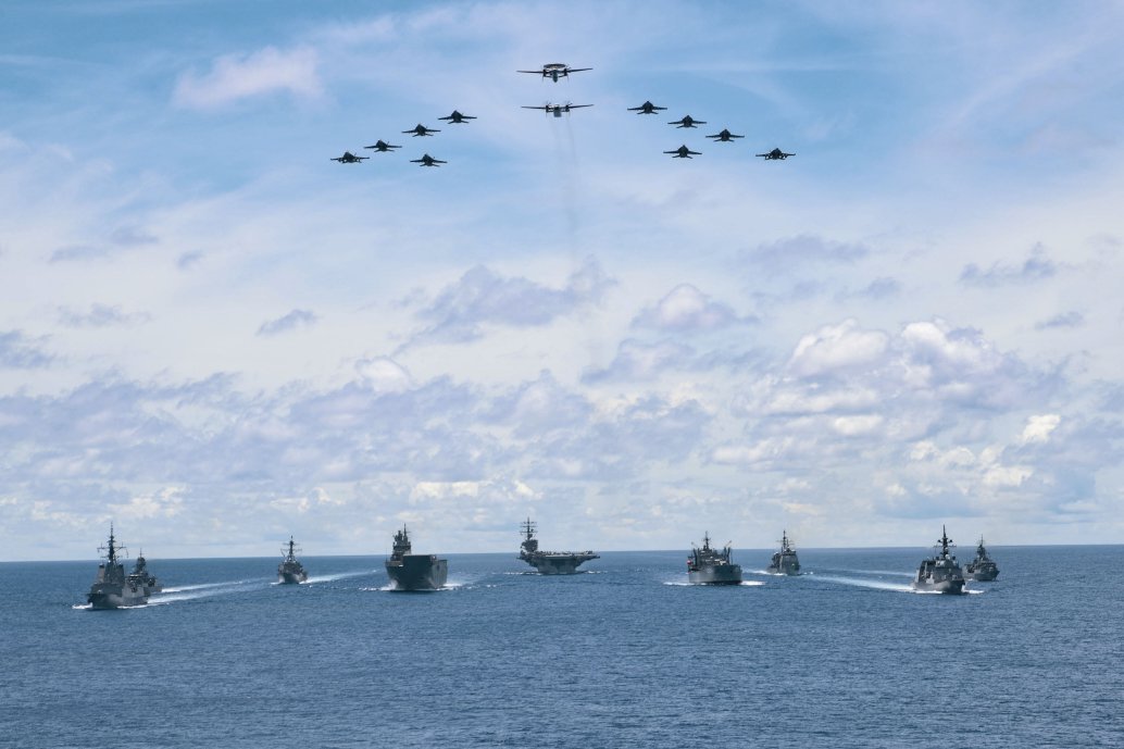 
        As aircraft from Carrier Air Wing 5 fly overhead, US Navy ships USS
        Ronald Reagan
        ,
        Antietam,
        and
        Mustin
        are seen here on 21 July taking part in a trilateral passage in the Philippine Sea with Royal Australian Navy ships
        Canberra
        ,
        Hobart
        ,
        Stuart,Arunta,
        and
        Sirius
        and Japan Maritime Self-Defense Force Akizuki-class destroyer JS
        Teruzuk
        i on their way to the 2020 edition of the multinational ‘Rim of the Pacific’ (RIMPAC) exercise in Hawaii. Washington reiterated that same day that it will continue to bolster its “growing network of Indo-Pacific allies and partners”, referring to US partnerships in the region as “a strategic advantage our competitors cannot match”.
       (Commonwealth of Australia 2020)