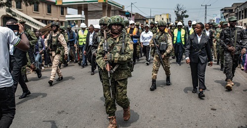 Photograph of Soldiers walking down the street as M23 North Kivu provincial leadership marked one year of M23's control of Goma