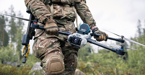 A British soldier holding a one-way effector UAV named