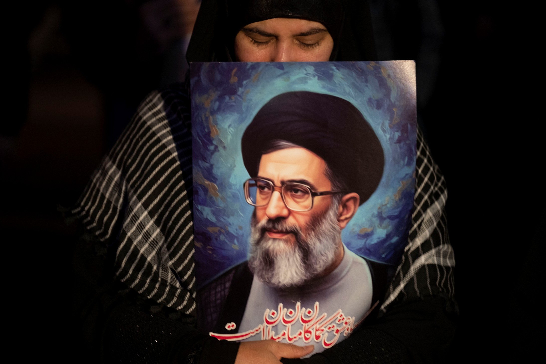 An Iranian woman holds a portrait of Iran's Supreme Leader Ayatollah Ali Khamenei while participating in a rally in Tehran, Iran, on March 1, 2026