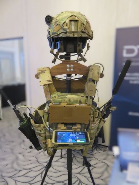 The DTC Dock Ultra on-the-man bridging system shown in March 2026, with (left) a Type 1 radio, (right) a MANET radio, and chest-mounted EUD and Dock Ultra.