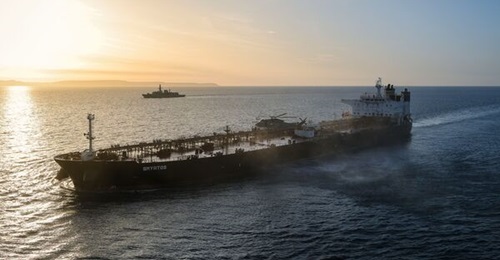 RM Commandos operating from a Merlin Mk 4 helicopter seize the tanker 
        
         on 14 June 2026. The frigate HMS 
        
         is in the background.