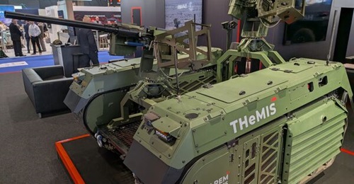 A quad C-UAV shotgun remote weapon station (at rear) integrated onto a Milrem THeMIS UGV, displayed at Eurosatory 2026.