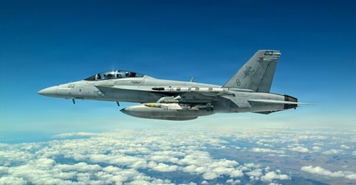 A Navy F/A-18 carries the new Joint Direct Attack Munition (JDAM) Long Range (LR) variant during a test event in early April 2026 off the coast of California.