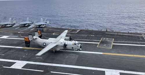 A C-2 Greyhound is shown landing on USS Nimitz. The aircraft carrier is now being considered for training operations.