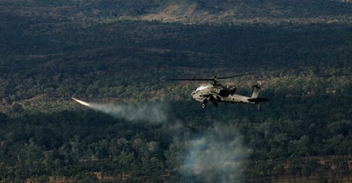 An Australian AH-64E Apache from the 1st Aviation Regiment conducts gunnery activities during Exercise 'Possum Guns' at Townsville Field Training Area in July 2026.