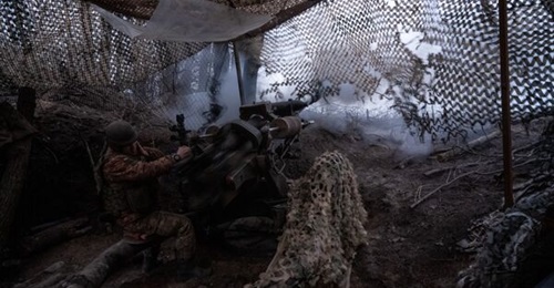 A gunner of the Ukrainian army's 95th Brigade firing an L119 Light Gun at Russian positions in the Lyman direction on 18 February 2024 at an undisclosed location in Ukraine.