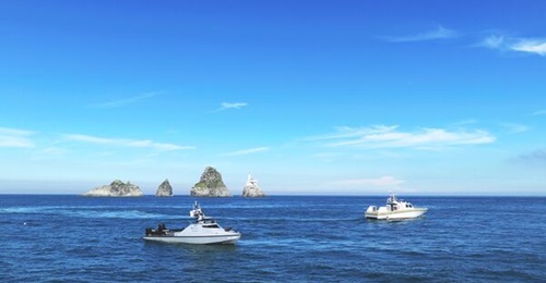 Hanwha Systems' Haeryeong reconnaissance USV (left) and the recently launched 30-tonne USV (right) during the MCM demonstration.