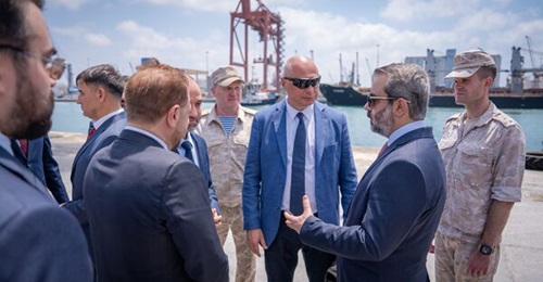 A Syrian delegation tours Tartus port's Pier 4 with Russian military personnel.