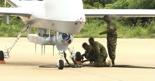 A still taken from the video released by the FACI shows Ivorian personnel working on a Wing Loong II UAV fitted with what looks like a COMINT pod.