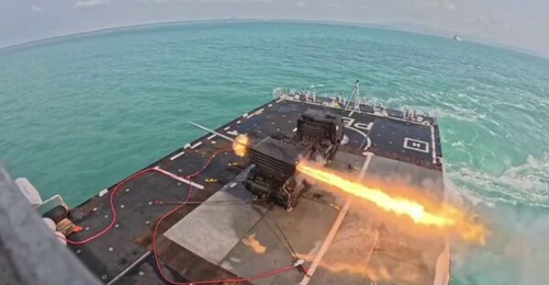 An Indonesian Marine Corps RM-70 122 mm MLRS system firing rockets from the flight deck of KRI 
        
         during a naval exercise in 2026.