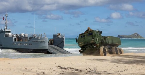 US soldiers assigned to the 7th Transportation Brigade execute a littoral rapid infiltration operation transporting High Mobility Artillery Rocket Systems using a Maneuver Support Vessel (Light).
