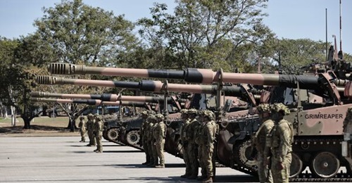 Personnel from 106 Battery, 4 RAA, alongside AS9s at a parade marking the introduction of the Australian Army's first protected mobile fires battery at Lavarack Barracks in Townsville.