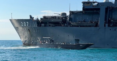 A fast craft utility (FCU) sailing past RSS 
        
         while making its way to the beach. Singapore has begun a process to replace its FCU and FCEP vessels.