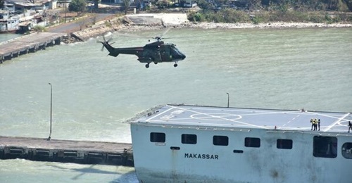 An Indonesian Air Force Super Puma helicopter landing on the flight deck of KRI Makassar.