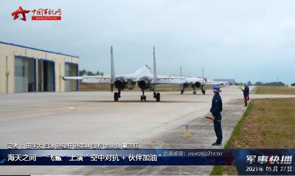 A screengrab from footage released by CCTV on 27 May showing two PLANAF J-15 multirole fighters about to take off from Lingshui Airbase on Hainan Island in the South China Sea. (CCTV)