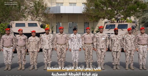 Major General Sheikh Ahmed bin Taihan al-Nahyan (centre) stands with Military Police officers in front of a Calidus MATV (left) and a Nimr Ajban.