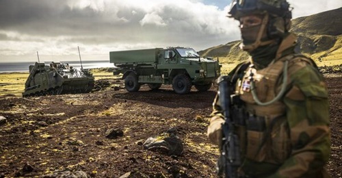 Norwegian Home Guard soldiers providing security for a StrikeMaster mobile anti-ship missile system followed by a NOMADS on Jan Mayen on 30 August.
