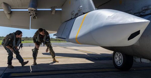 Personnel from the Royal Australian Air Force's No 1 Squadron conduct a pre-flight check of a JASSM-ER loaded on a F/A-18F Super Hornet at RAAF Base Amberley, in November 2025.