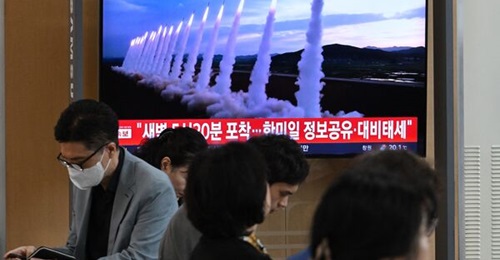 A television at a railway station in Seoul shows footage of a North Korean missile test on 12 September, as passengers wait nearby.