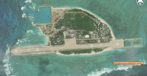 Vantor imagery shows Thitu Island in the South China Sea. Land reclamation at the eastern end of the island will aid in extending the runway, while earlier land reclamation allowed the construction of a new harbour.