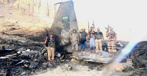 Houthi militants pose with the wreckage of a Saudi Arabian combat aircraft shot down on 16 September 2026.