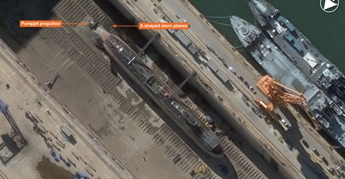 Vantor imagery shows a Type 095 SSN in dry dock at Huludao in China. The pumpjet propulsor and X-shaped stern planes are clearly visible.
