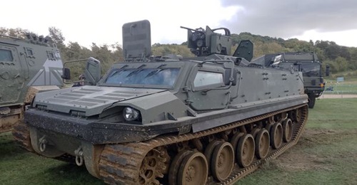 A Patria TRACKX tracked vehicle with a Kongsberg Protector RS4 remote weapon station mock-up and a 12.7 mm machine gun (dummy version) at the Defence Vehicle Demonstration (DVD) 2026 exhibition held in Millbrook, UK, on 16-17 September 2026.