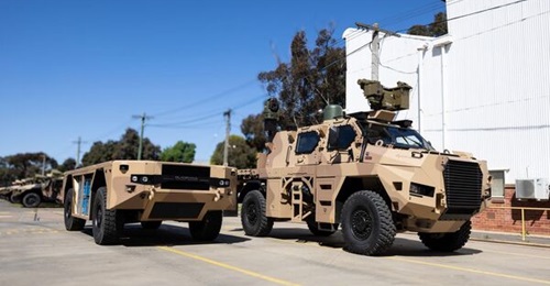 A BladeHAUL UGV is photographed alongside a Bushmaster PMV.