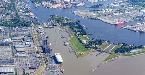 Aerial view of Emden Port and the Große Seeschleuse lock, with vessels navigating the River Ems and industrial facilities along the waterfront.