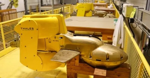 Line of CAPTAS-2 towed array sonar systems in a manufacturing facility.
