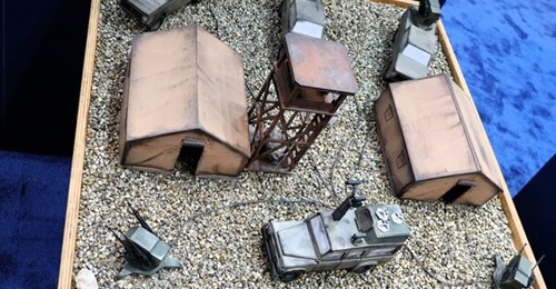 Model showing Kolarms' Ares Shield complex, using a mobile command vehicle which can launch interceptor UAVs, and several mobile and static Nemesis turrets.