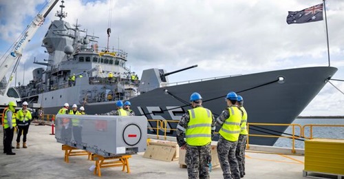 An inert operational missile sits on the wharf in front of the frigate HMAS Ballarat during Naval Strike Missile handling training in Henderson, Western Australia.