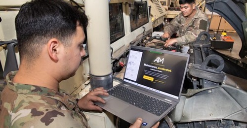 US soldiers perform maintenance on a Humvee using the Artificial Intelligence-Assisted Maintenance (AIAM) tool.