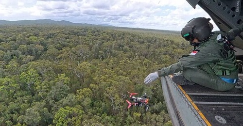 An RSAF crew member deploying an FPV drone from a CH-47.