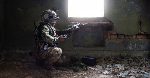 A Canadian drone pilot launches an FPV UAV during a in exercise by NATO's Multinational Brigade in Latvia in August 2026.