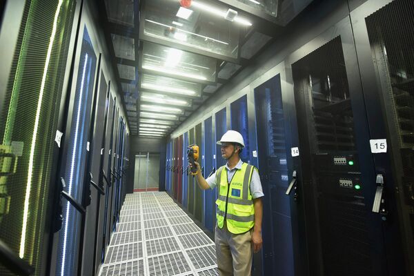 An employee monitors computer server racks at a cloud computing data centre in Hangzhou, China. (Costfoto/Barcroft Media via Getty Images)