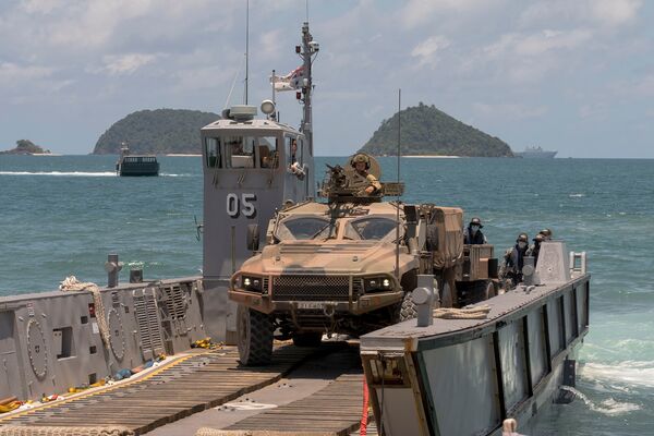 
        An Australian Army Hawkei PMV-L reverses onto a light landing craft from HMAS 
        Adelaide
         at Cowley Beach in Queensland during Exercise ‘Sea WADER 2020'. The DoD announced on 11 July that the Hawkei has achieved IOC.
       (Commonwealth of Australia)