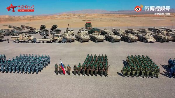 A screengrab from footage released by CCTV on 9 August showing Russian and Chinese troops, along with related equipment, during a ceremony held that day at the Qingtongxia combat training base in China's Ningxia Hui Autonomous Region to mark the start of the five-day-long ‘Sibu/Interaction 2021' strategic military exercise. (CCTV)