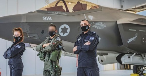IAF personnel pose in front of one of six F-35I Adir aircraft that have been deployed to Italy for the service's first overseas exercise using the type.