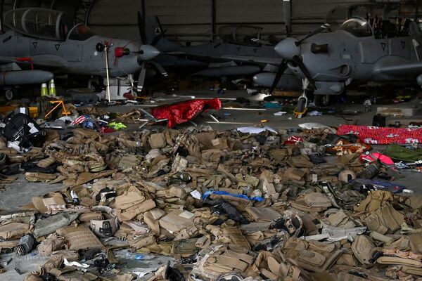 Sets of body armour along with several AAF A-29 light attack aircraft inside a hangar at Kabul airport on 31 August. The Pentagon said that before leaving Afghanistan, US troops disabled 73 aircraft at the airport, almost of all which had belonged to the AAF. (Wakil Kohsar/AFP via Getty Images)