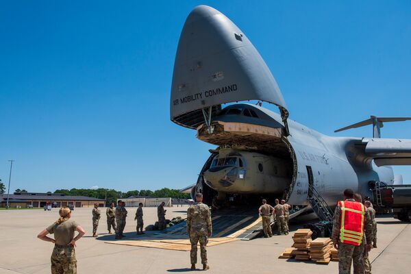 A Boeing CH-47F Chinook is removed from the cargo area of a Lockheed C-5M Galaxy at the Seymour Johnson Air Force Base in North Carolina on 18 June 2021. The USAF used C-17As and C-130s for its evacuation of Kabul instead of the C-5M, despite the Super Galaxy being the largest aircraft in the USAF's fleet. (US Air Force)