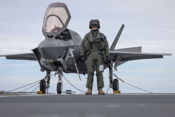 F-35B pilot, Squadron Leader Will, stands in front of his aircraft aboard 
        Prince of Wales
        .
       (Crown Copyright)