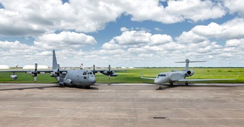 The first EC-37B 'Compass Call' (right) next to one of the EC-130Hs (left) it is intended to replace.