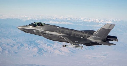 An F-35A fires an AIM-9X missile from the its external wing against an aerial drone target at Point Mugu Test Range, California.