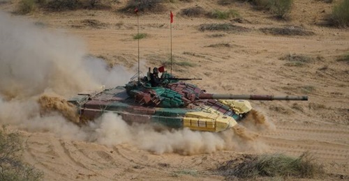 The armament of the T-72 MBT, pictured above taking part in an Indian Army exercise in November 2022, includes a 125 mm smoothbore 2A46 main gun, a 7.62 mm co-axial machine gun mounted to the right of the main gun, and a 12.7 mm Nikitina-Sokolova-Volko...