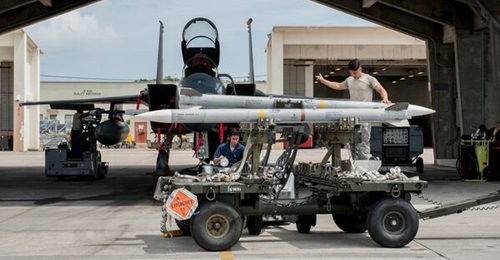 US Air Force maintainers prepare to load AIM-120-C-7 AMRAAMs on a USAF F-15 on Okinawa in 2016. A proposed new sale of AIM-120 and AIM-9 Sidewinders to Japan has the goal of improving the ability of JASDF's F-15, F-35, and F-2 fleets to meet current an...