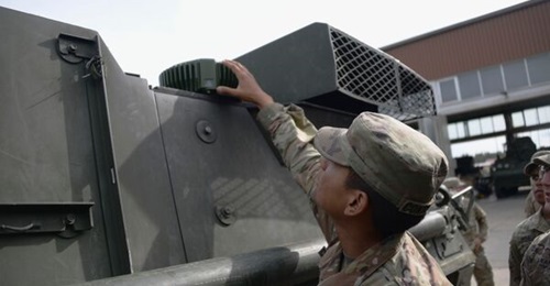 A US Army soldier with the 2nd Squadron, 2nd Cavalry Regiment, inspects a MAPS Gen 1 A-PNT component installed on a tactical vehicle.