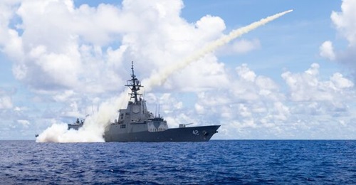 A Royal Australian Navy Hobart-class guided-missile destroyer fires a Harpoon surface-to-surface missile during Exercise 'Pacific Vanguard' 2022. The class will be equipped with the Naval Strike Missile in the future.