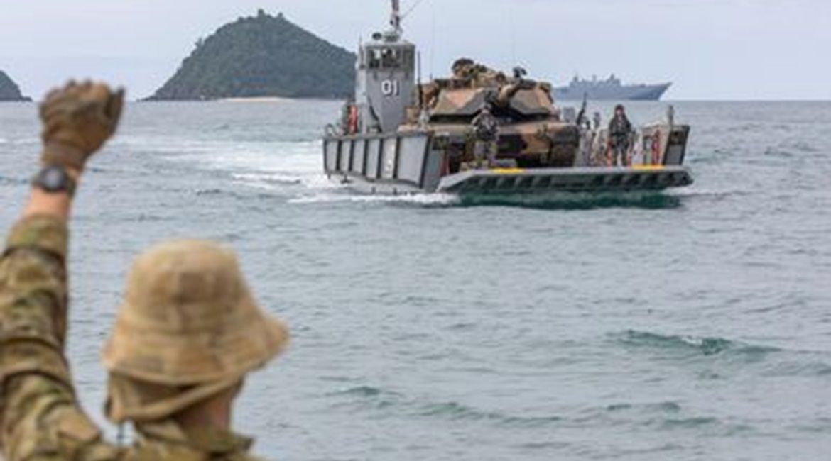 A Royal Australian Navy LHD landing craft carries an M1A1 Abrams main battle tank from HMAS 
        
         during an amphibious beach assault, as part of Exercise 'Sea Explorer'.